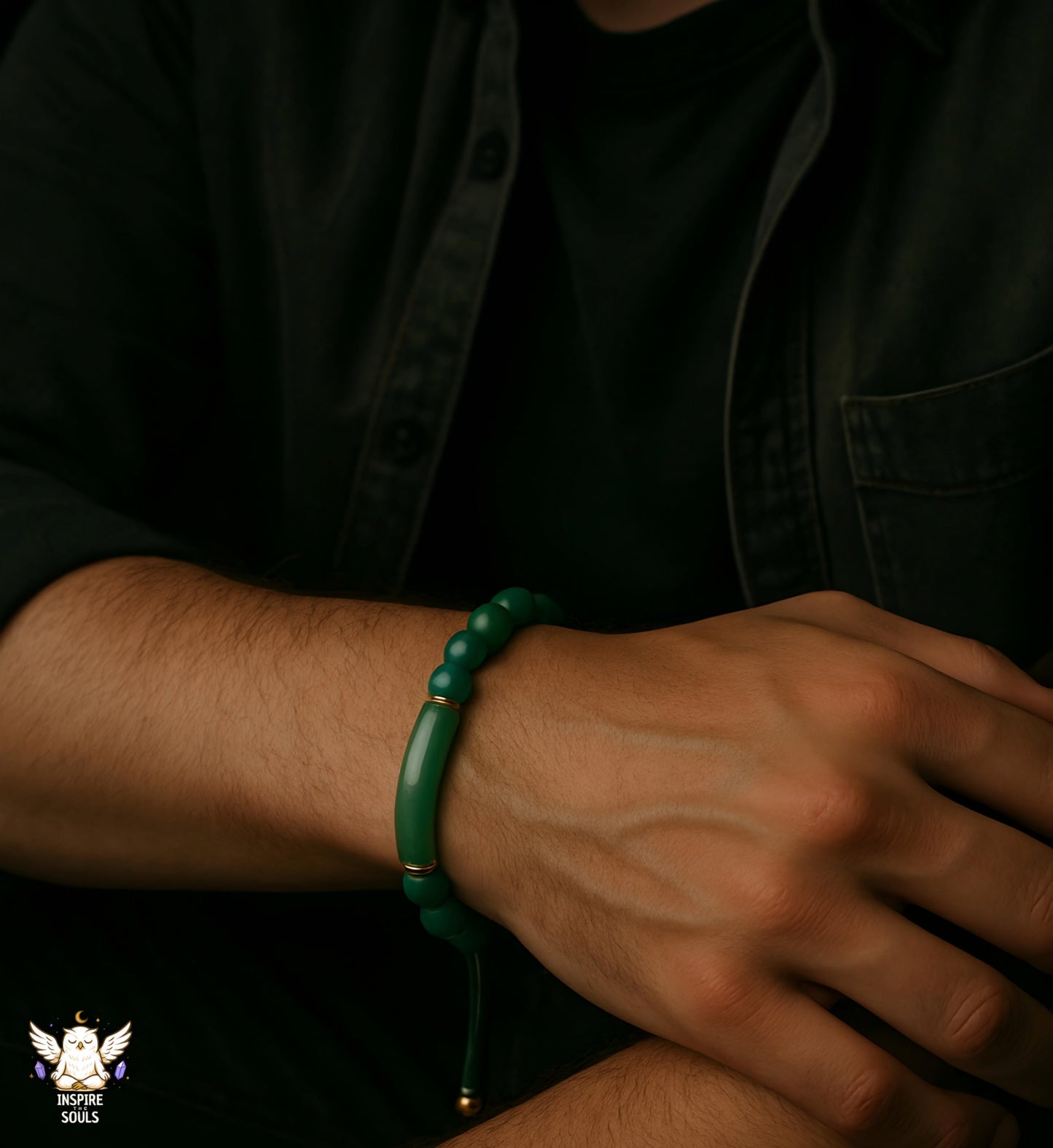 Close-up of a wrist wearing a green bracelet with a dark background