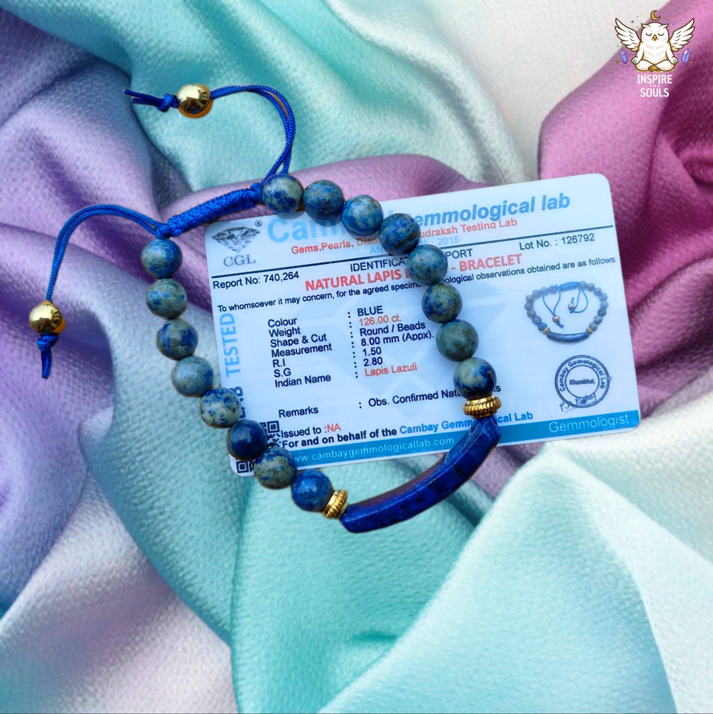 inspirethesouls lapis lazuli bracelet bracelet with a certification card on a colorful fabric background