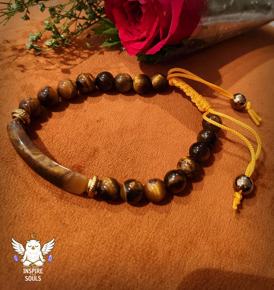tiger eye soulstone series by Inspirethesouls bracelet with yellow cord on a wooden surface with a pink rose in the background